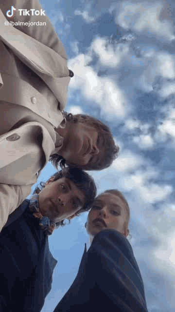 a group of people looking up at the sky with tik tok written on the bottom