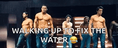 a group of shirtless men are walking up to fix the water on a stage .