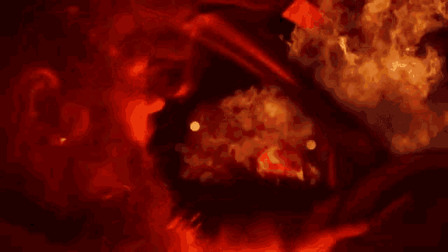 a car is on fire and smoke is coming out of it in a dark room .