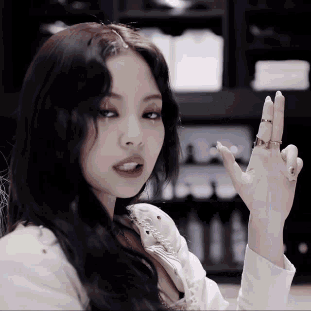 a woman with a ring on her finger is making a funny face