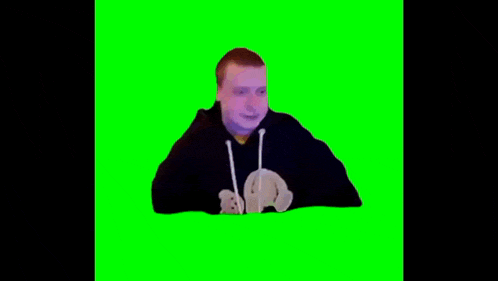 a man is laying on his back on a green screen and drinking from a bottle .