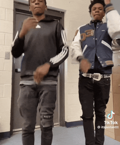 two young men are dancing in a hallway and their tiktok is titled itsjustantt