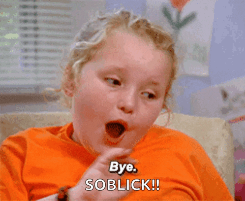 a little girl in an orange shirt is saying bye soblick