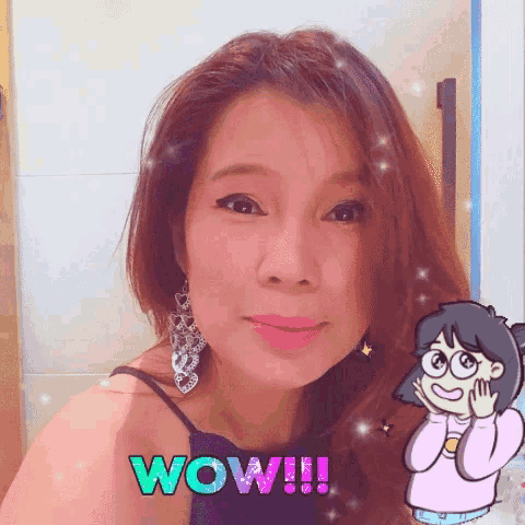 a woman is wearing a black top and earrings and has the word wow written on her face