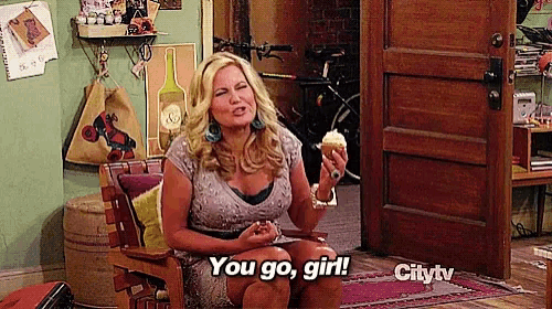 a woman is sitting in a chair holding an ice cream cone and says you go girl