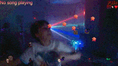 a boy is dancing in a room with the words " no song playing " behind him