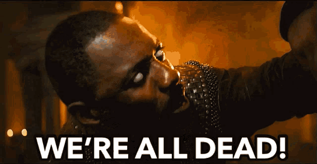 a man is saying we 're all dead while holding a gun