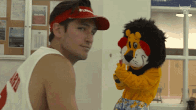 a man wearing a red visor that says puma on it