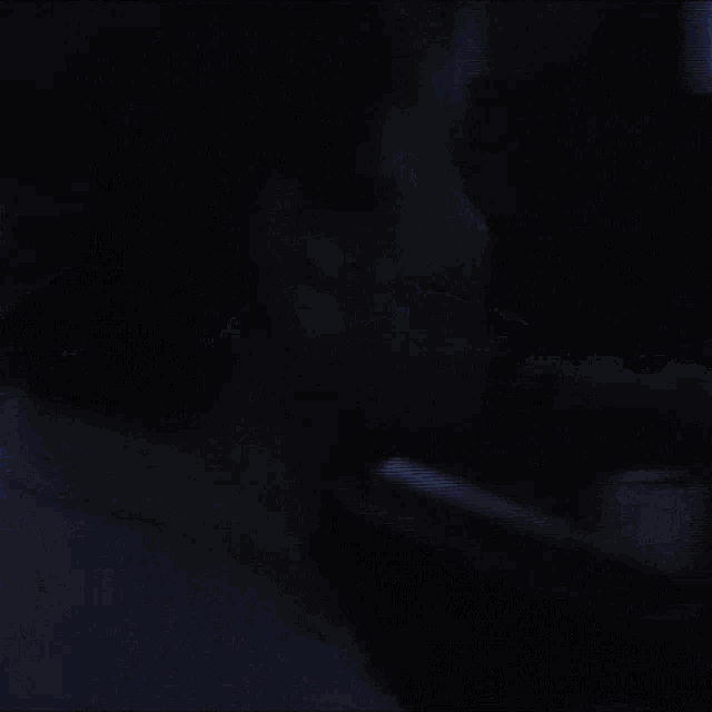 a blurry picture of a person standing in a dark room