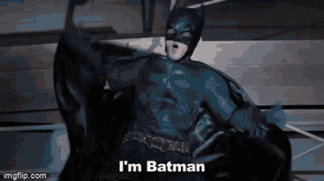 a man in a batman costume says i 'm batman in a gif
