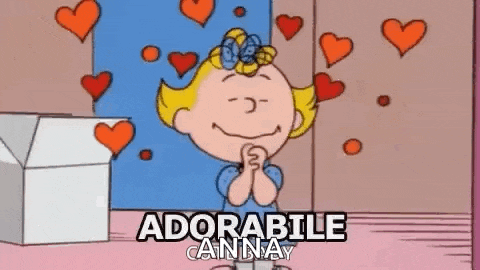 a cartoon of a girl with hearts around her and the words `` adorabile anna '' written above her .