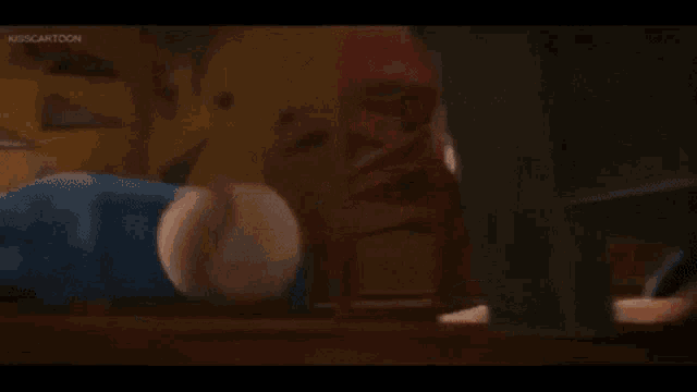 a cartoon boy is playing with a stuffed animal in a bedroom .