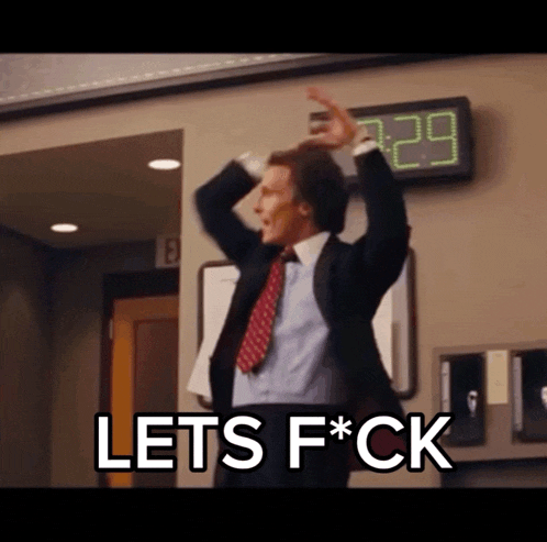 a man in a suit and tie is standing in front of a clock that says 3:29