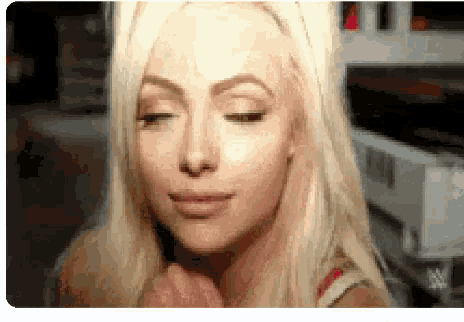 a close up of a woman 's face with her eyes closed and her hand on her face .