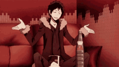 a man is sitting on a couch with his arms outstretched and a bottle of soda .