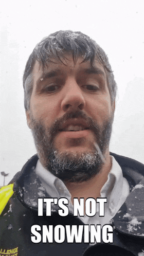 a man with a beard is wearing a jacket that says challenge