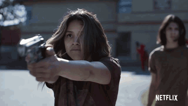 a netflix ad shows a girl pointing a gun at someone