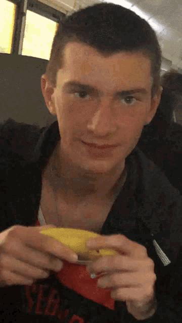 a young man in a black shirt with the word serv on it