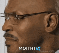 a man with glasses and a mustache is making a funny face