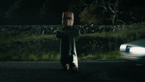 a car is driving down a road at night and a person is flying through the air