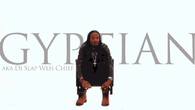 a man is sitting in a chair with the word gyptian written above him