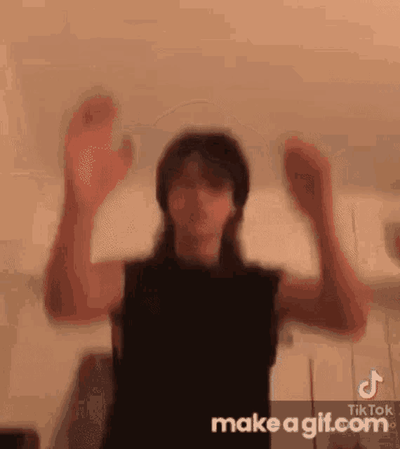 a man is dancing with his arms in the air .