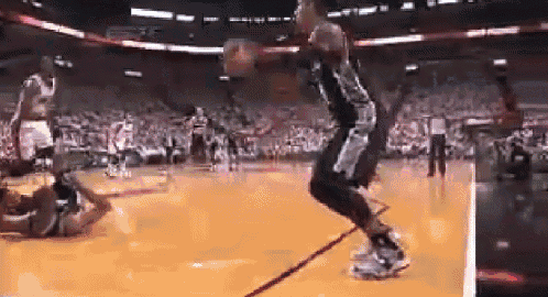 a basketball player is jumping in the air while holding a basketball
