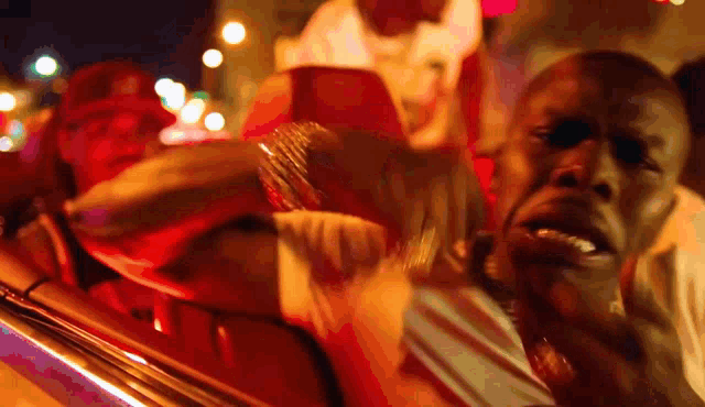 a blurry picture of a man 's face while sitting in a car at night