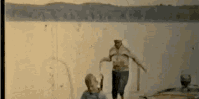 a man and a woman are standing in front of a lake .