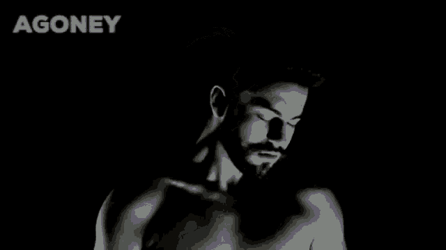 a shirtless man with a beard is in the dark .