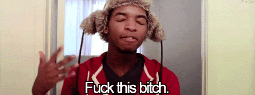 a man wearing a fur hat and a red hoodie says " fuck this bitch "
