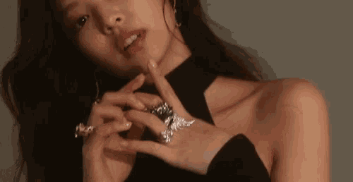 a close up of a woman 's neck and hands
