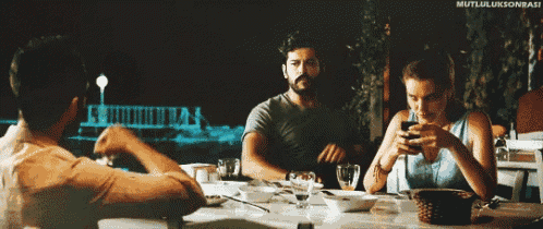 a group of people sitting at a table with mutluluksonrasi written on the bottom