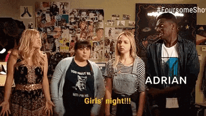 a group of young people are standing in a room .