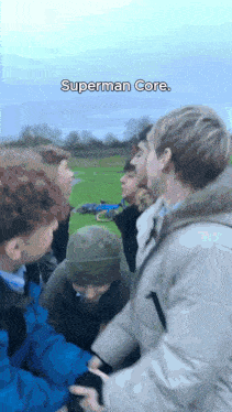 a group of young men are standing in a field and the caption says superman core