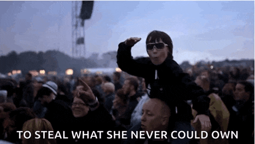 a girl is riding on a man 's shoulders with the words to steal what she never could own written below her