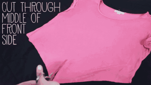 a person is cutting through the middle of the front side of a pink shirt