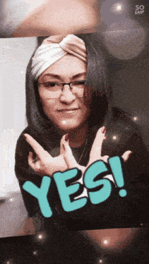 a woman wearing glasses and a headband with the word yes on her face