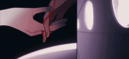 a close up of a person holding another person 's hand with blood coming out of it .