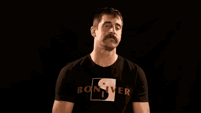 a man with a mustache wearing a black shirt that says boxer