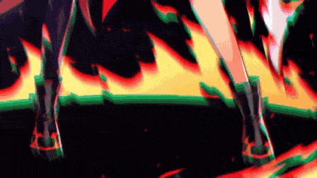 a close up of a person 's feet standing in front of a fire .