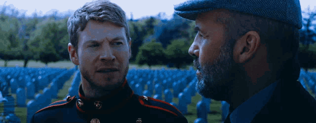 a man in a military uniform talks to another man