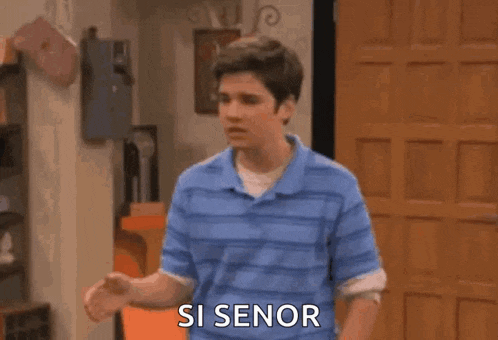 a man is screaming with his arms in the air and the words `` si senor '' written on the screen .