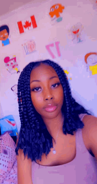 a girl is taking a selfie in front of a wall with cartoon characters on it