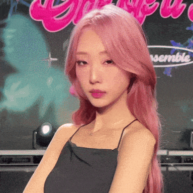 a girl with pink hair is standing in front of a sign that says " ensemble "