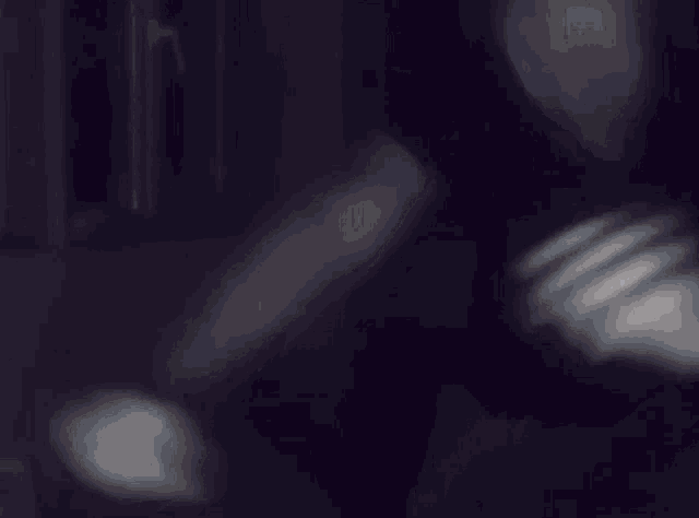 a blurry picture of a person 's face in the dark