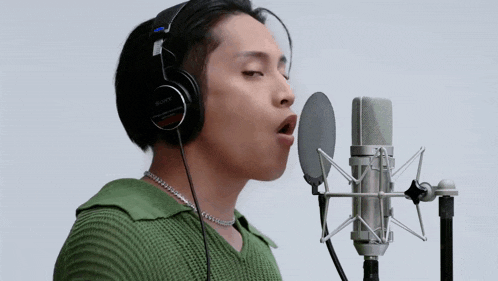 a man is singing into a sony microphone