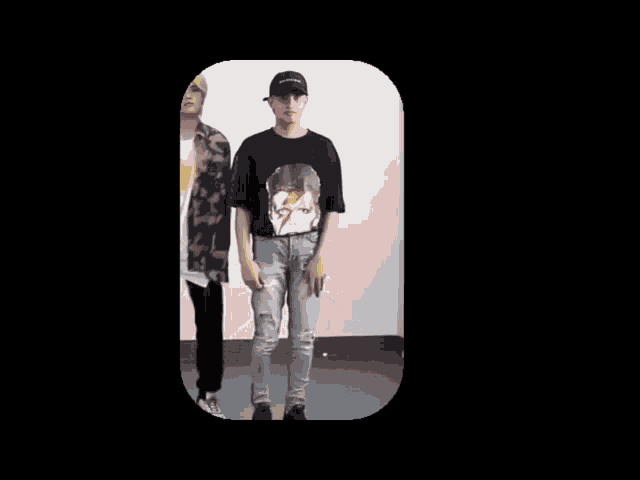 a man wearing a black shirt with the number 1 on it is dancing