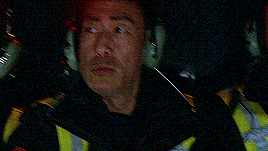 two men wearing headphones and headsets are looking at a screen .