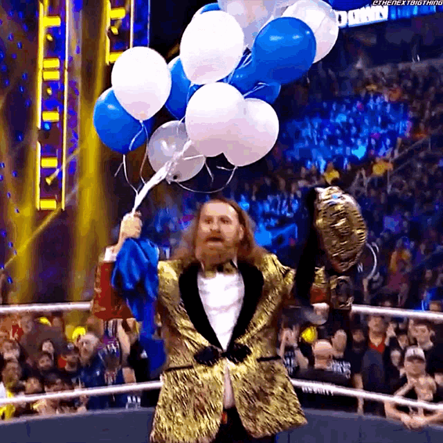 a man in a tuxedo is holding a bunch of balloons in front of a crowd